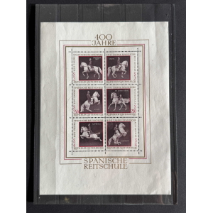 Block of six Austrian postage stamps commemorating 400 Jahre Spanische Reitschule, each showing a rider on a horse in dressage poses with maroon backgrounds and fine borders.
