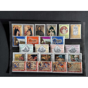 A stamp collection display with Vatican stamps organized in rows, featuring religious portraits and scenes in various colors and denominations.