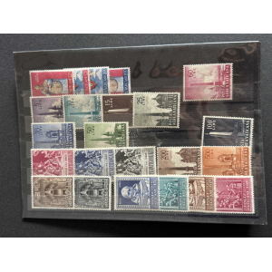 Collection of colorful Vatican City postage stamps arranged on a black page in a clear plastic sleeve.
