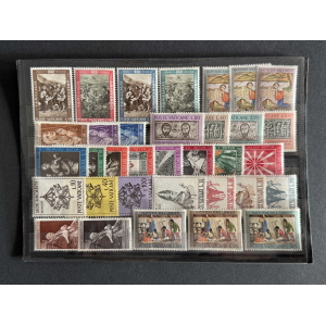 Sheet of assorted Vatican postage stamps in a protective sleeve, showing colorful designs and various denominations.
