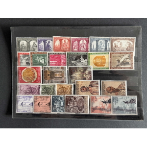 Page of colorful postage stamps in a binder, mostly Vatican and Papal states issues with portraits and buildings laid out in rows.