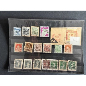 BM_1225_f-1.jpg A page from a stamp album showing multiple Swiss Helvetia stamps arranged in rows on black strips, with cancellation marks and a brown manila envelope on the right side.