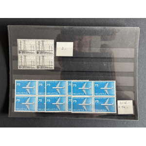 Sheet of vintage Swiss stamps: four gray 3‑Helvetia marks in a 2x2 block atop a black album page, plus a row of blue 75‑Helvetia Swissair stamps with airplanes below.