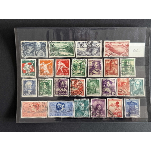 Assorted vintage Helvetia Pro Juventute postage stamps in a plastic display sleeve, arranged in rows on a black background.