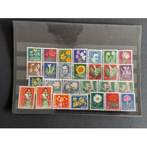 Sheet of colorful vintage Swiss postage stamps on a black display page (Helvetia).