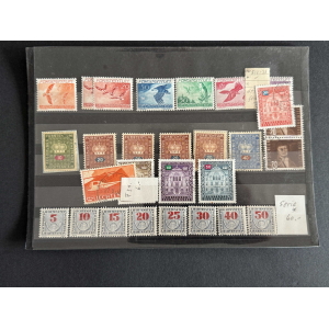 Liechtenstein postage stamps arranged on a black binder page, featuring multicolored stamps in rows with various denominations and designs.