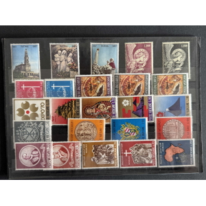 Sheet of Vatican stamps in a binder, showing churches, saints, and religious motifs in multicolor designs.