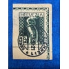 globalcollection.ch - Green Swiss stamp with a worker bending over, holding a tool; 'HELVETIA' at the top and decorative border, canceled with a circular postmark