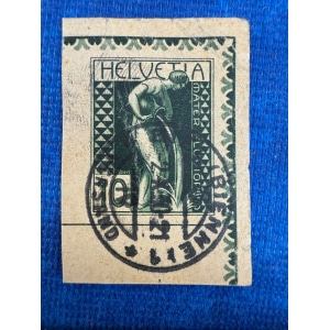 BM_0607_f.jpg Green Swiss stamp with a worker bending over, holding a tool; 'HELVETIA' at the top and decorative border, canceled with a circular postmark