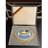 globalcollection.ch - Enamel award medal in a presentation box: blue circle with a racing car, checkered flag, ‘GUSTAV PETER’, and ‘SCUDERIA HANSEAT’ inside a gold laurel wreath; ribbon with German colors is visible in the lid.